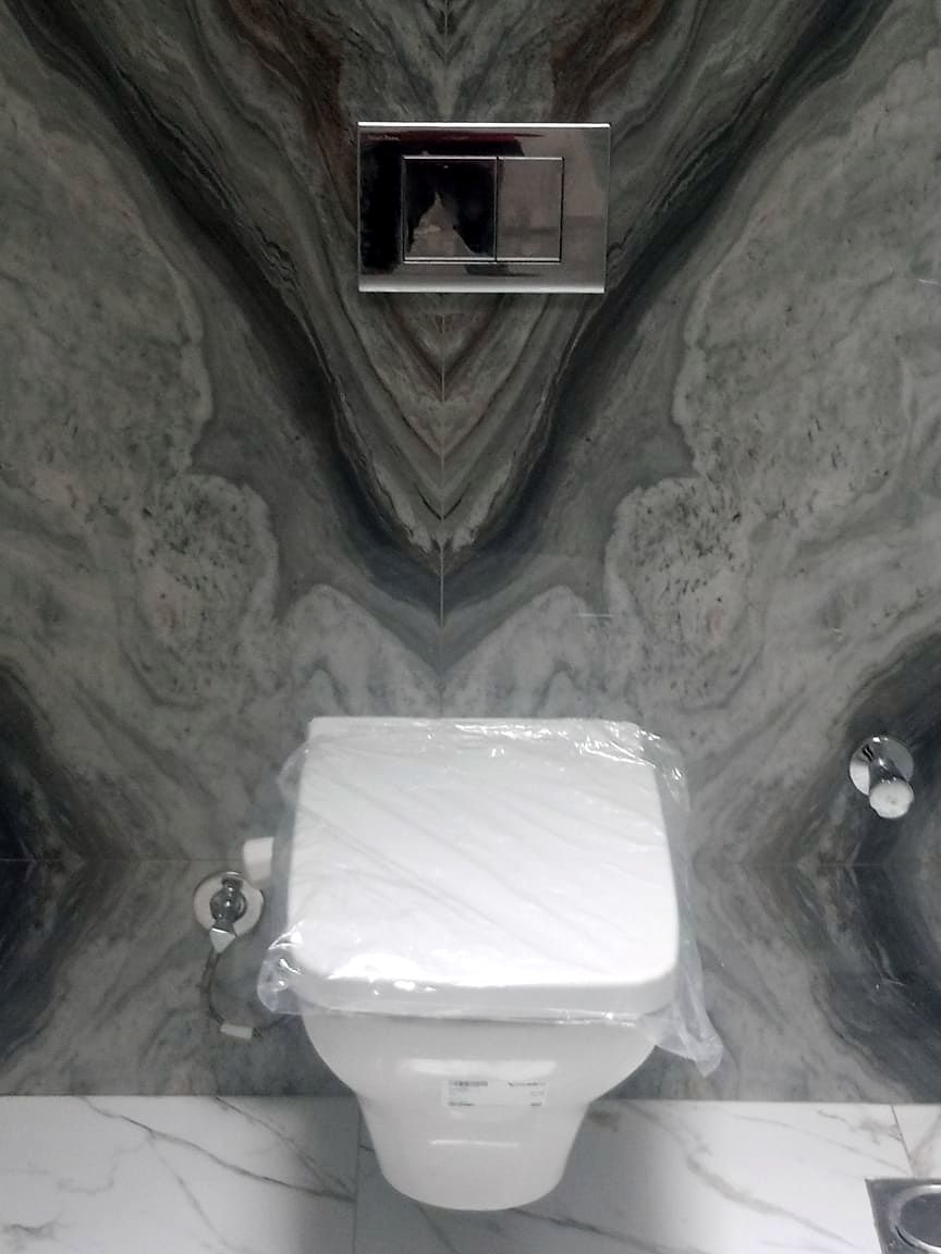 Book-matched marble wall panel set on site