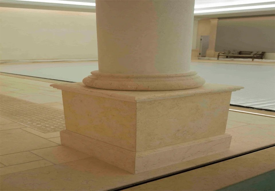 Sunny Light column base and moulded plinth beside an indoor pool
