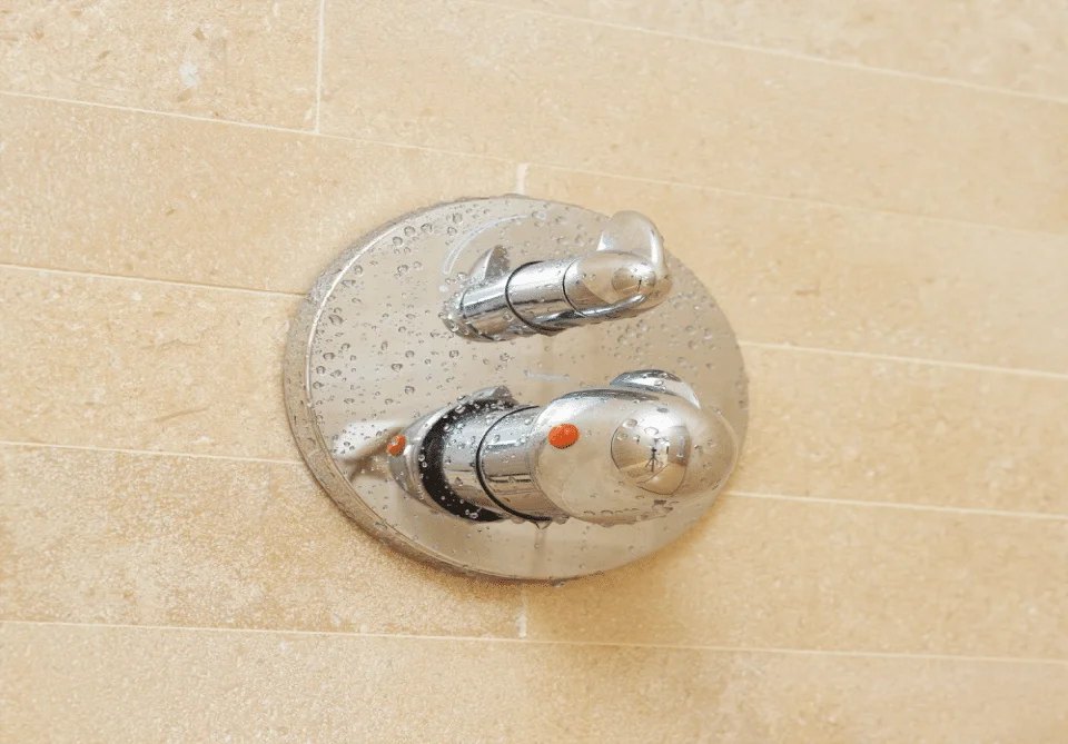 Concealed thermostatic valve set into a Sunny Light shower wall