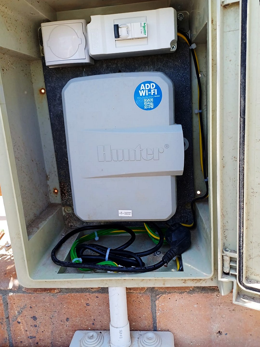 Hunter irrigation controller in its weatherproof cabinet