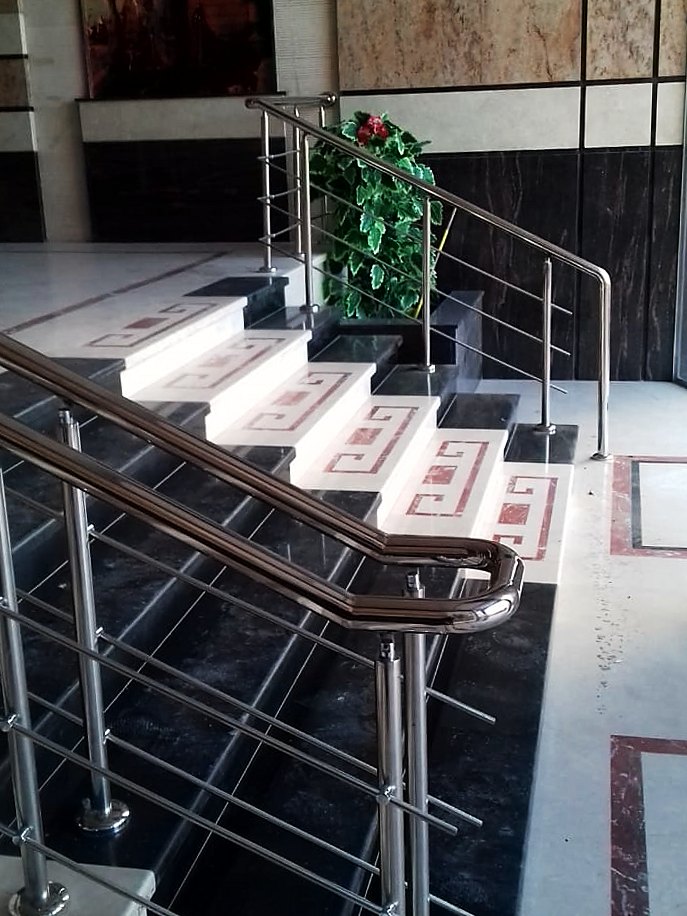 Lobby steps with Greek-key marble inlay and planter
