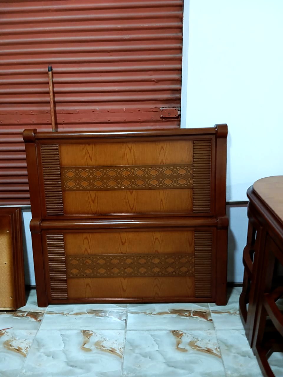 A headboard and footboard with a pressed diamond band, ready to go out