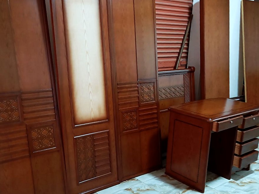 Cherry-stained bedroom furniture from our workshop, waiting to be assembled