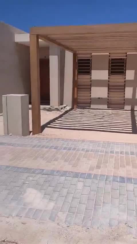 Villa entrance with a pergola, louvred shutters and interlock paving — on site
