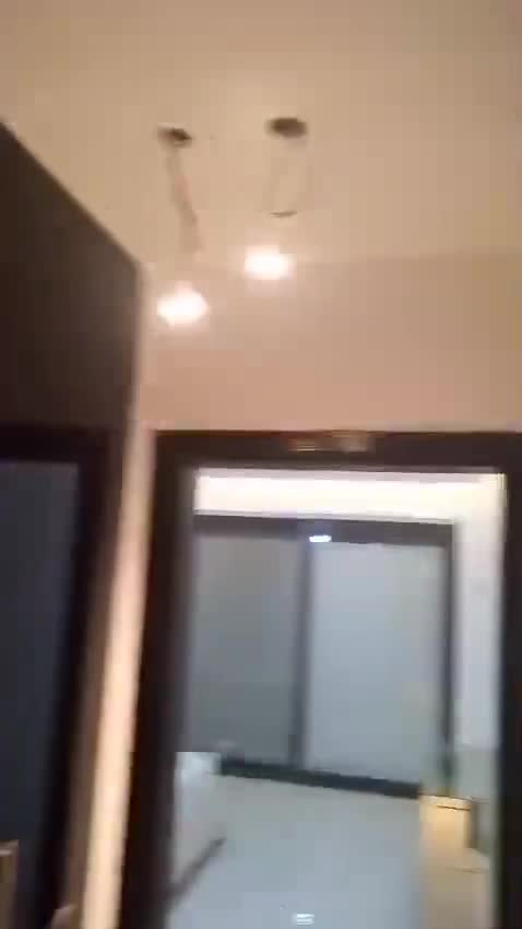 Finished room with pendant lights and a sliding glass door — on site