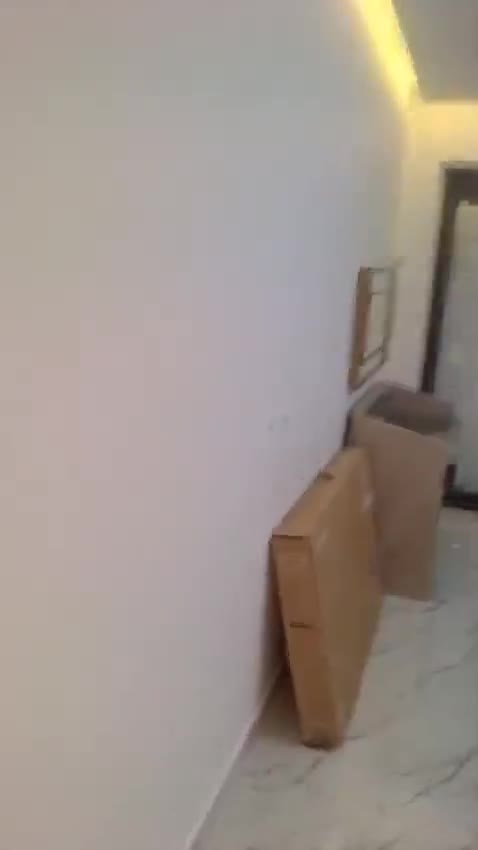 Painted room with marble-look floor tiles and packed boxes — on site