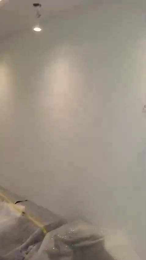 Freshly painted room with a downlight, floor still under protective sheeting — on site