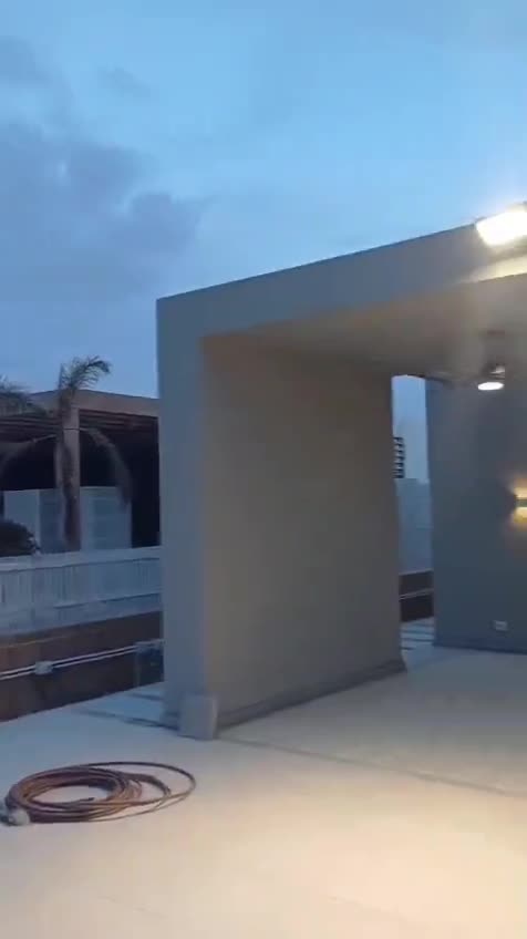 Entrance canopy of a finished villa at dusk — on site