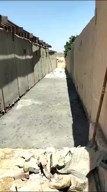 New concrete floor in a long passage between walls
