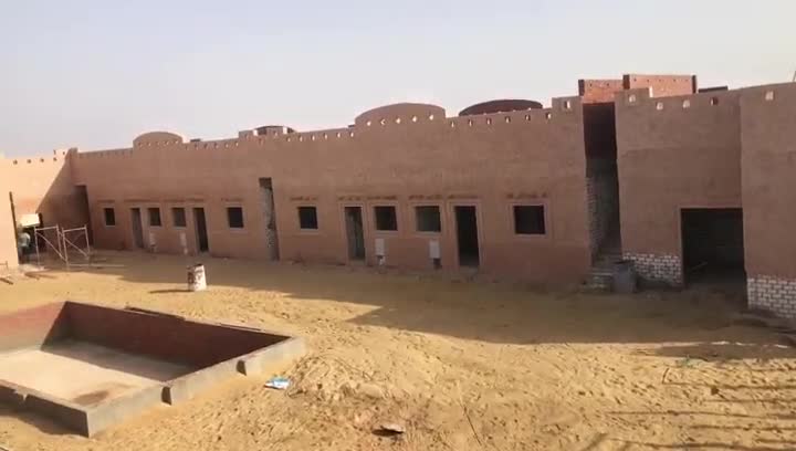 Courtyard of a single-storey complex; facades rendered, doors and windows not yet fitted