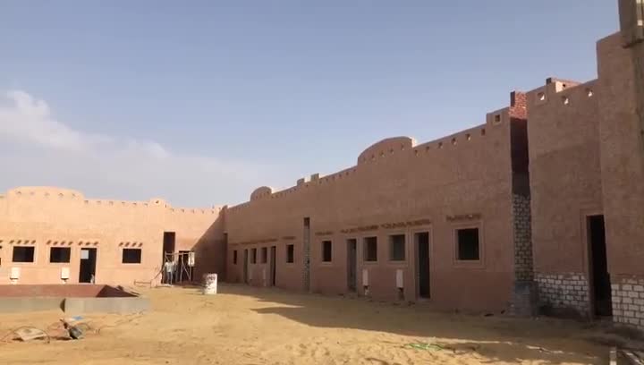 Panorama of the courtyard and rendered facades, openings still empty