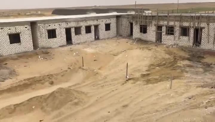 Block buildings in shell stage with earthworks